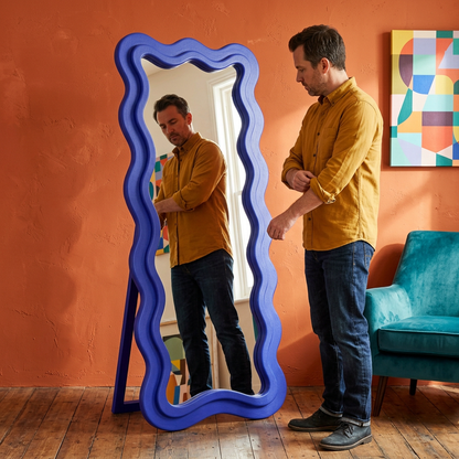 Cobalt blue wavy mirror used in a colorful creative home studio