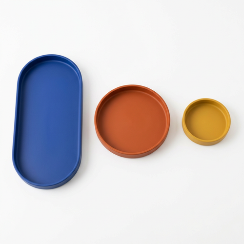 Three colorful catchall trays on white